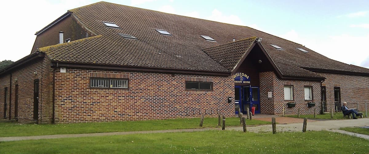 A brick building with a sloped roof and skylights.