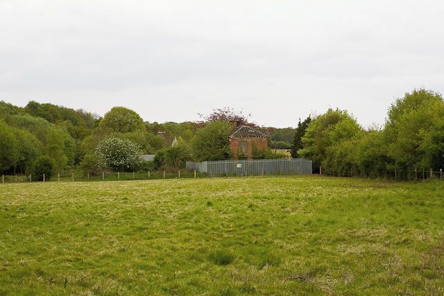 Derelict Cottage on old pump house site, Mayles Lane The metal fencing was put up in 2008 for health and safety reasons. The wooden posts are for another fence in process of being erected at time of photographing. The old pump house itself is beyond the cottage.