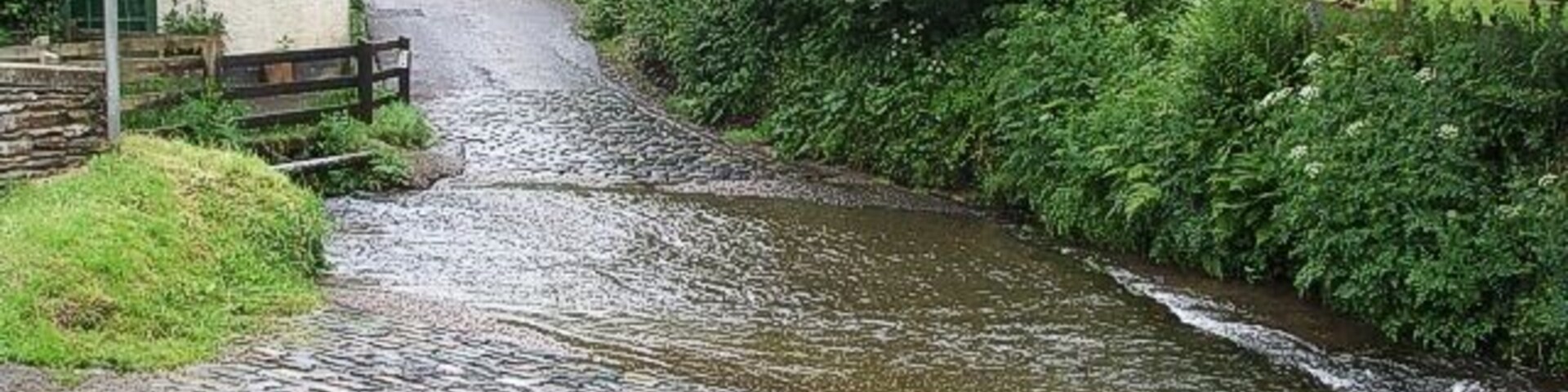 The Ford, Winsford Just what it says on the sign. Here a tributary stream of the River Exe crosses Ash Lane out of Winsford. This lane leads eventually to Withypool.
