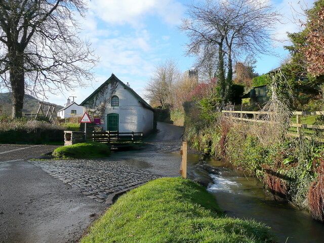 Winsford, Somerset A pretty village on the south side of the Exmoor Hills. The road to Withypool fords the Winn Brook with the church tower of St. Mary Magdalene beyond.
