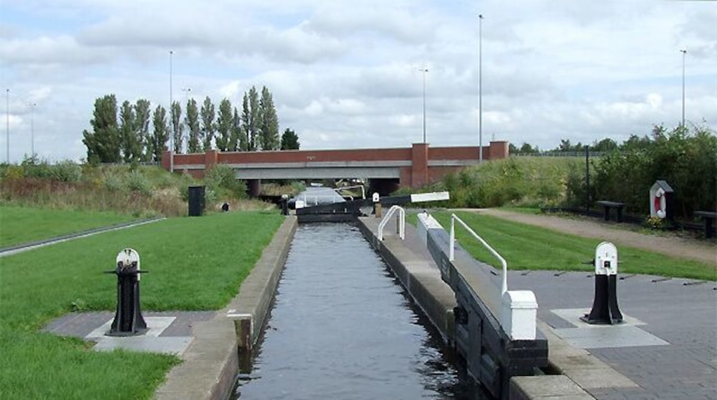 Curdworth Top Lock, Birmingham and Fazeley Canal, Warwickshire There are eleven locks, some widely spaced, in the flight at Curdworth. The total drop in water level over about three miles is 76ft 4in (23.3 metres). Ahead, the M6 toll motorway (opened in December 2003) crosses the canal. The canal was opened in 1789.