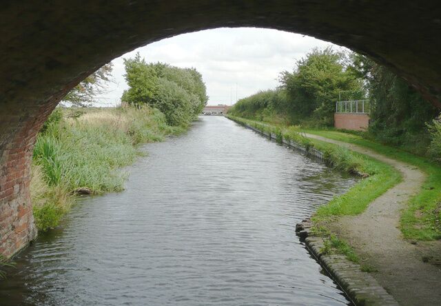 Birmingham and Fazeley Canal north of Curdworth, Warwickshire Seen from beneath the arch of Baylis's Bridge, and looking towards Curdworth Top Lock and the M6 (Toll) bridge.