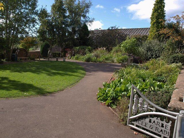 Jubilee Gardens, Wiveliscombe "The gardens were opened in 1977 ... to commemorate Queen Elizabeth II's Silver Jubilee. Now part of The Wiveliscombe Heritage Arts Trail, they were updated in 2004 by the addition of very fine sculpted gates and innovatively carved oak seats ... The Gates: Bristol-based sculptor, Steve Joyce, began by taking plaster hand-casts from a wide variety of local people aged between five and ninety. These were then cast in metal and incorporated in the final design together with the names of the shopkeepers who originally traded from the site on which the gardens now stand." http://www.wiveliscombe.com/the_jubilee_gardens/