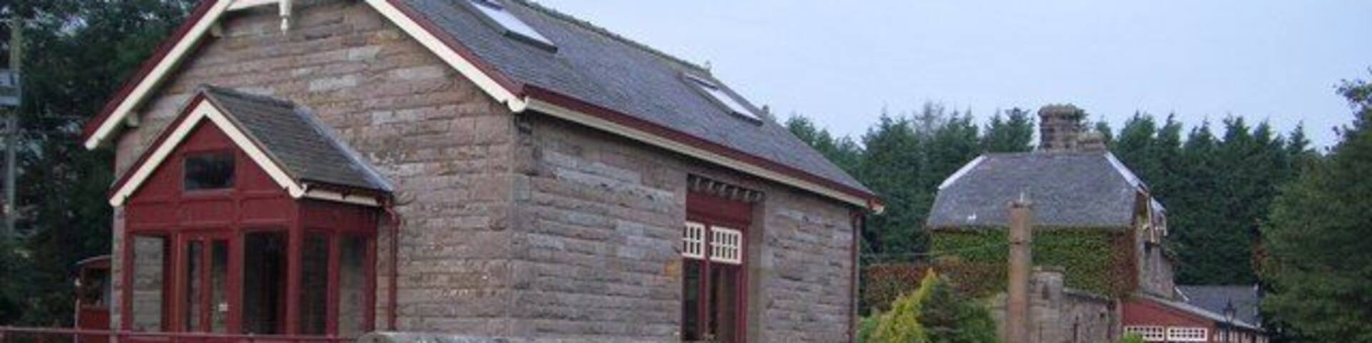 Former Railway Freight Warehouse at Akeld Station Freight and agricultural traffic continued along this part of the railway from Cornhill (Coldstream) until 1965. Grain and fertiliser were stored in the warehouse until collected by farmers, and heavy goods were loaded on and off the trains by a one ton crane located by the entrance to the warehouse, now converted. The former edge of the station platform is visible in this view.