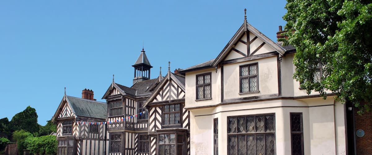 A Tudor-style house with a garden in front.
