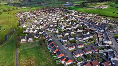 Aerial drone view of Residential housing homes Ballyclare Town in Antrim Northern Ireland UK