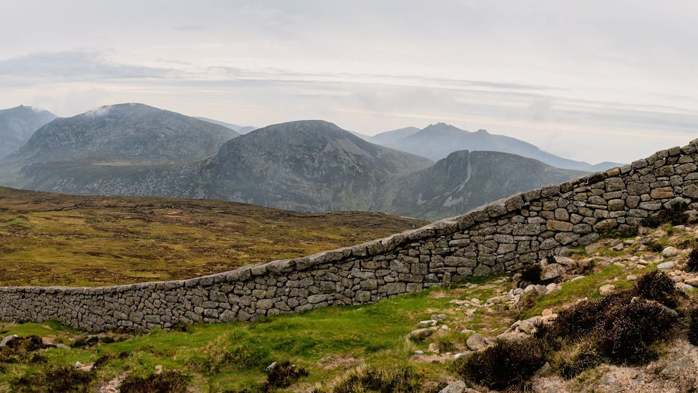 Panoramic view of typical Irish landscape, fields, sea in background. Picture taken from the top of Mourne mountains
