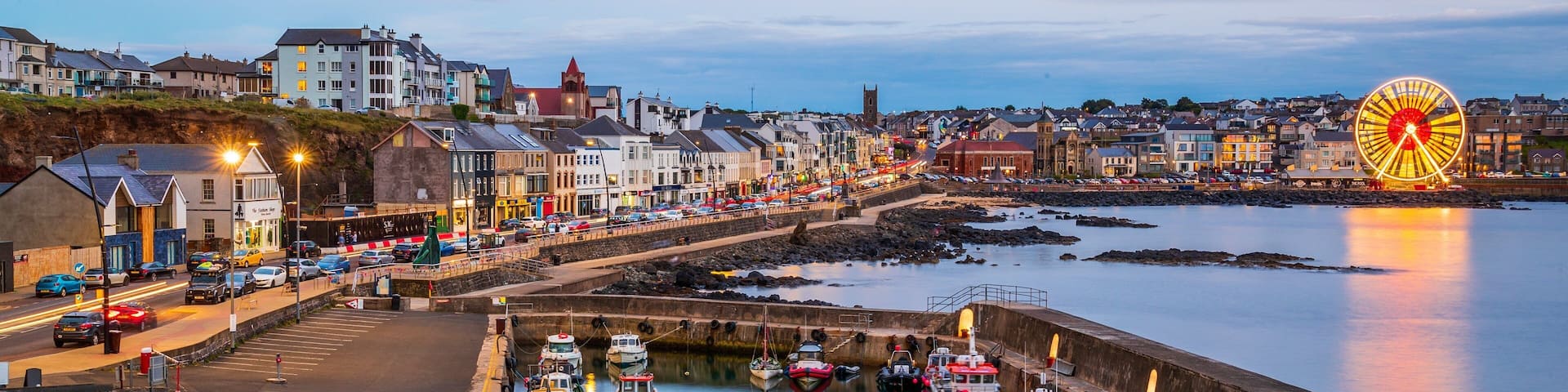 Portstewart which includes a city, night scenes and a bay or harbor