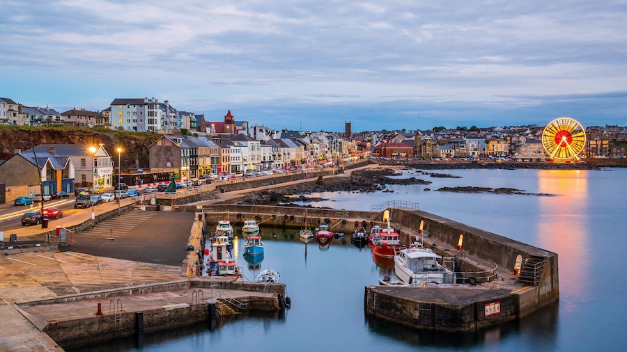 Portstewart which includes a city, night scenes and a bay or harbor