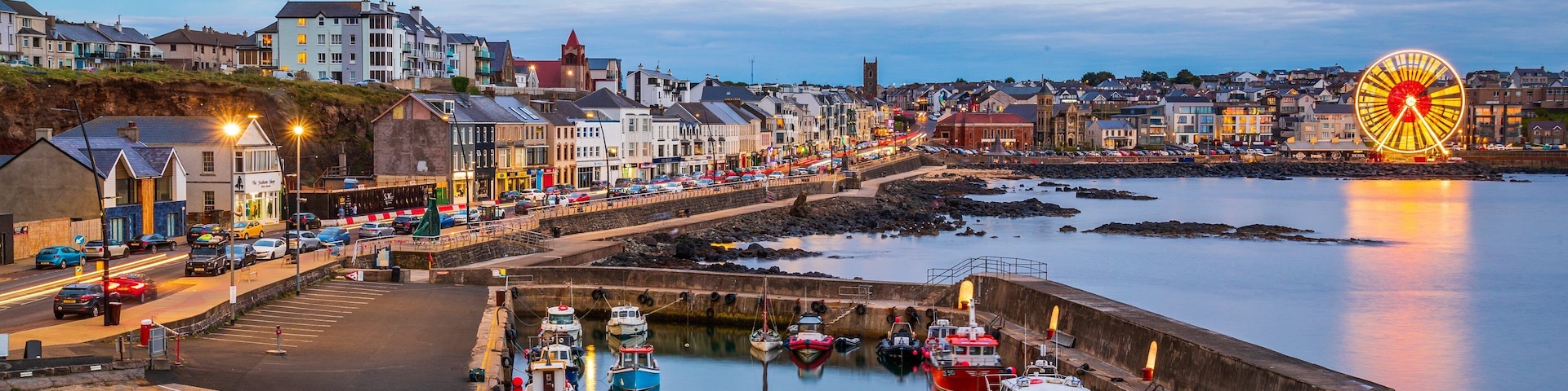 Portstewart which includes a city, night scenes and a bay or harbor