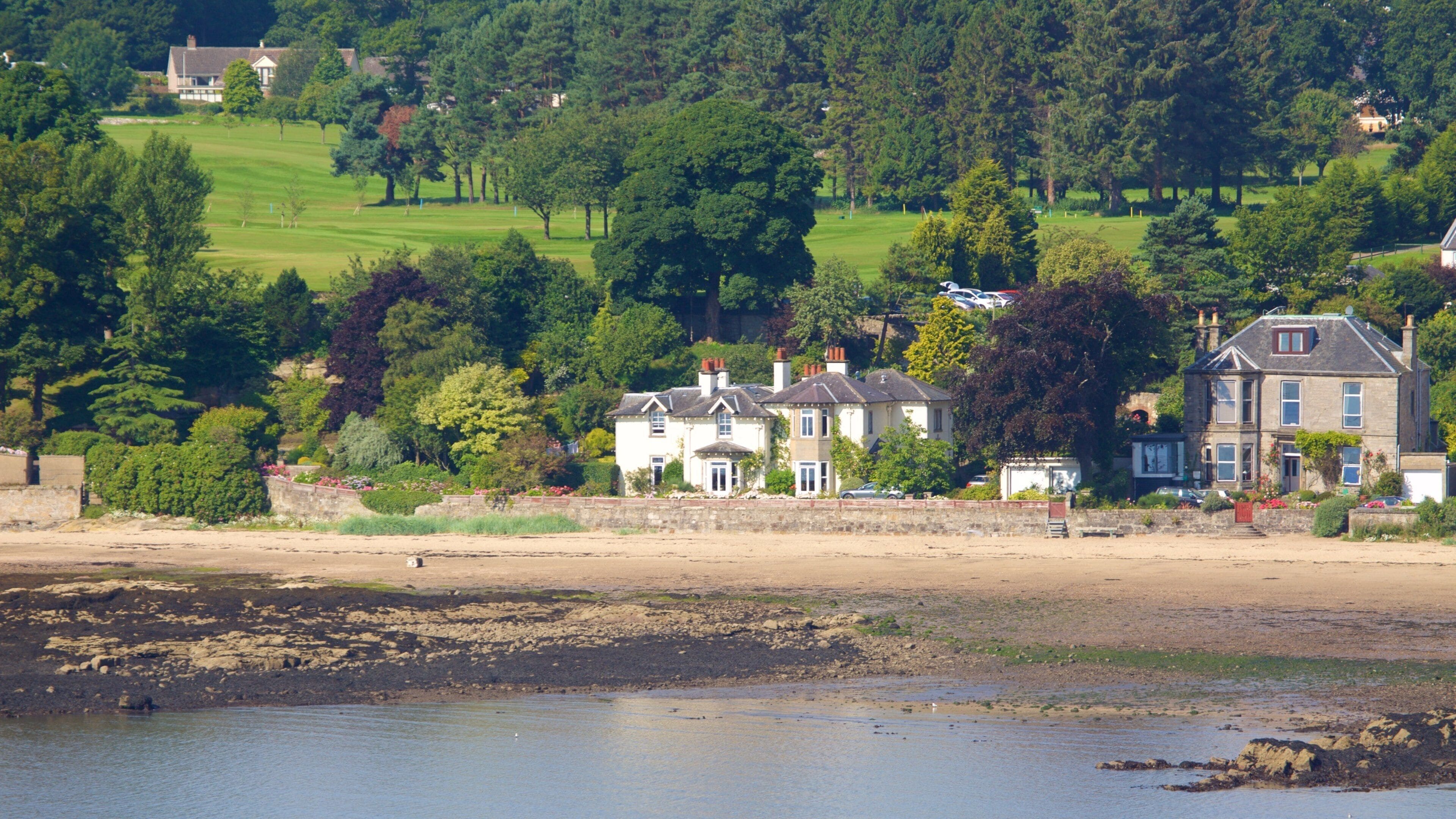 Aberdour showing a coastal town, a beach and rugged coastline
