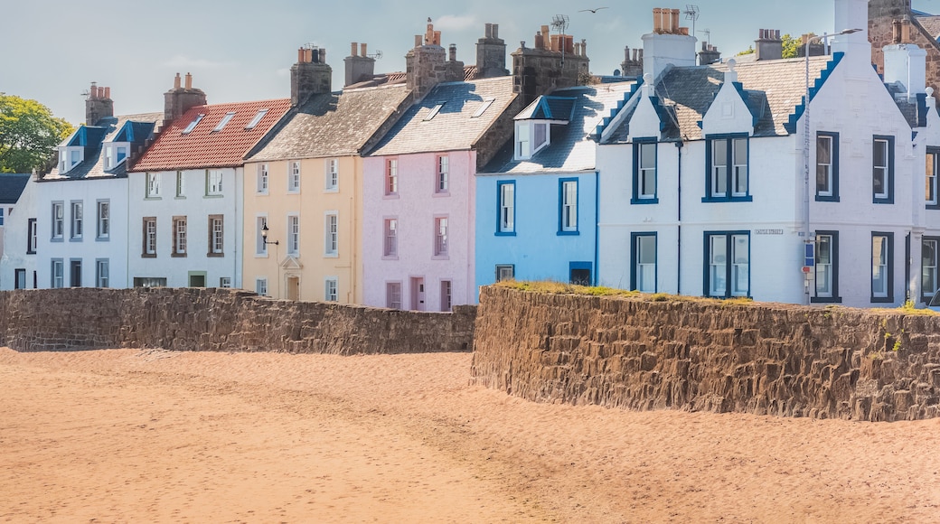 A colourful row of seaside houses on the sandy beach of the quaint coastal fishing village of Anstruther, East Neuk, Fife, Scotland, UK on a sunny summer day.