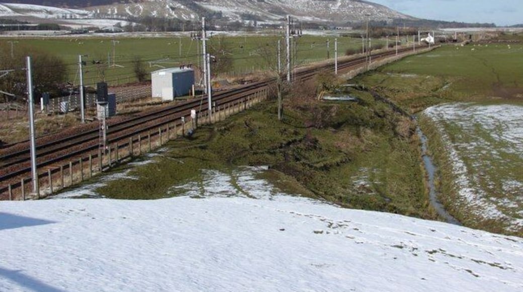 Site of Lamington rail station Looking along the main west-coast rail-line as it heads north past the site of the former Lamington station on a wintry day. The station itself closed and disappeared in the late 1960s.