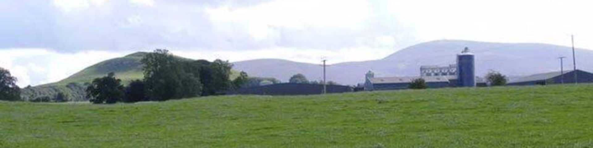 Quothquan Law and Tinto Looking south west from Eastertown farm towards Quothquan Law on the left and Tinto mountain on the right. The silhouette of Roadhead farm can be seen in the middle distance.