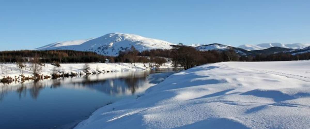 The River Spey Passing fields north of Kinchurdy Farm. Craiggowrie is the prominent hill in the distance.