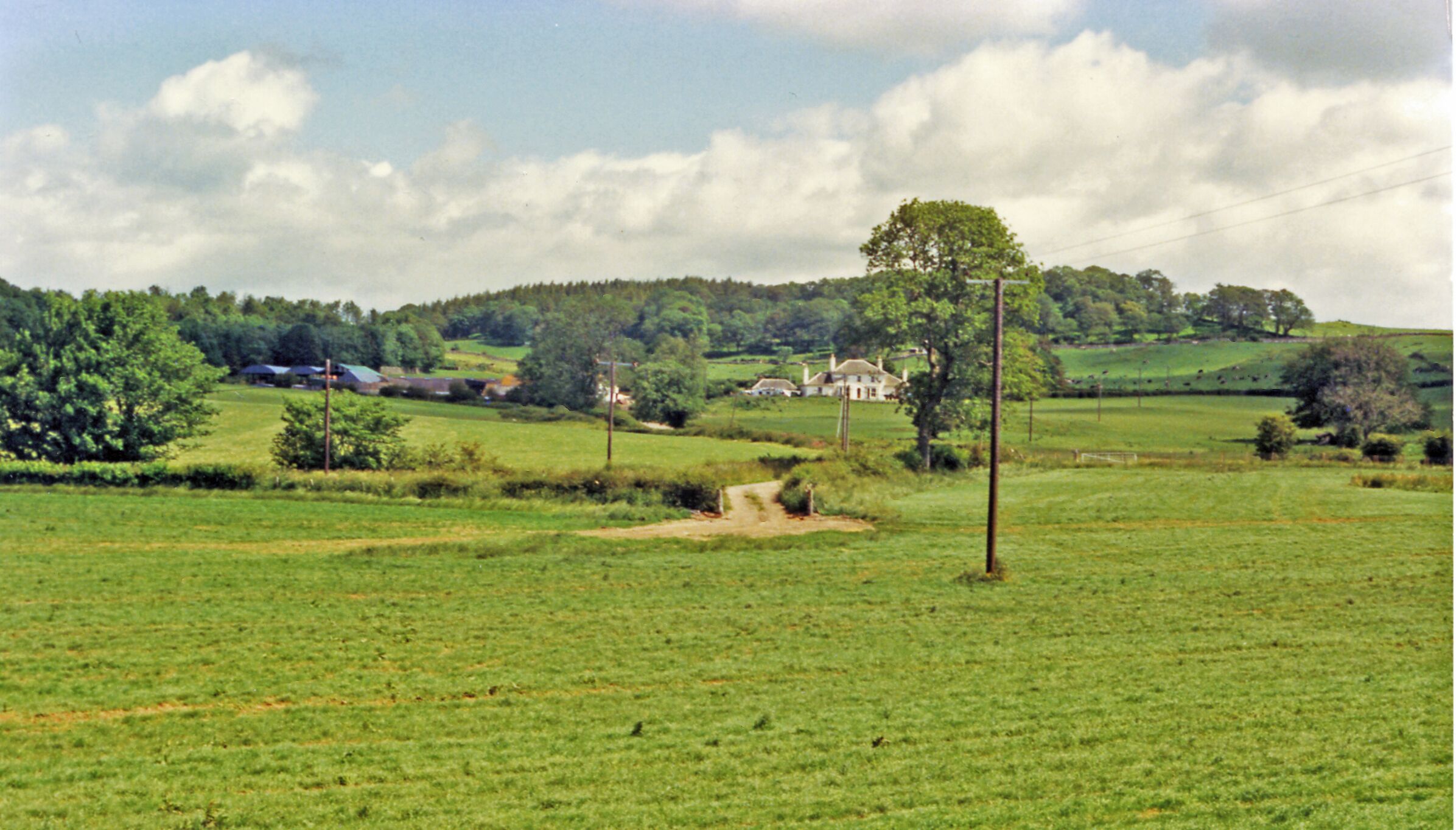 Cally House, Gateshead-of-Fleet, from A75 by-pass, 1986. View NE from the A75 (Gretna - Dumfries - Stranraer) road on its by-pass of Gatehouse-of-Fleet. This must be Cally House, but seems somewhat more modest than the present Hotel.