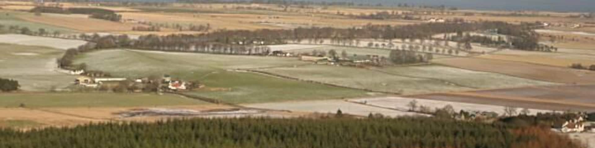 View from Dummiefarline Despite its modest height Dummiefarline has a commanding view of the flat land west of Loch Leven. Castle Island NO1301 in Loch Leven can be seen just to the left of West Lomond. NO1906 In the foreground is the forestry plantation which sweeps around two sides of the ancient hill fort.