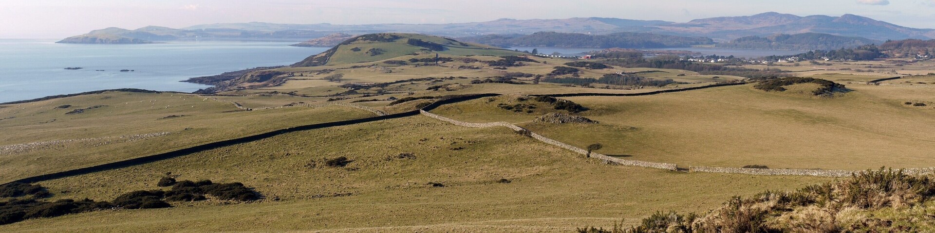 Panorama south-west of White Hill The view takes in the long inlet of Rough Firth from Heston island, with Balcary Point behind, on the left, Rough Island and Rockcliffe on the right. The distant hills on the right are Bengairn and Screel.