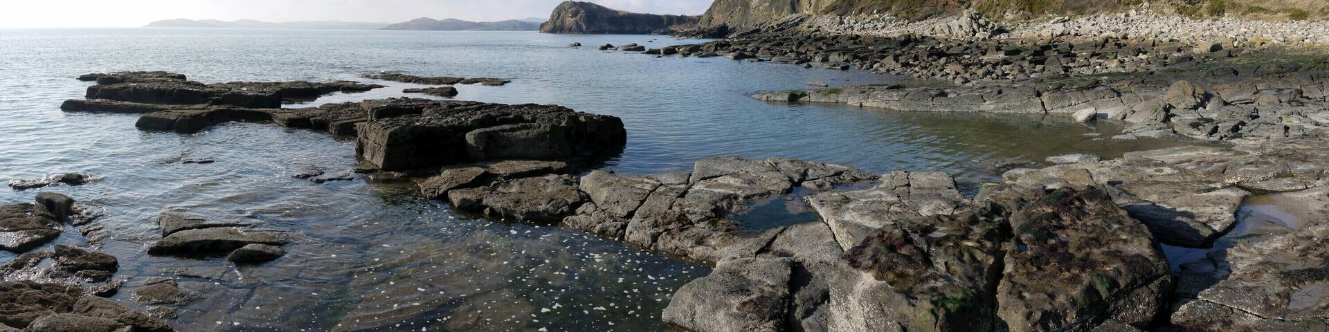 Coastal scenery west of Glenstocken Sands. Castlehill Point (locally Castle Point) 1464000, in the centre of the panorama, juts out below Barcloy Hill.