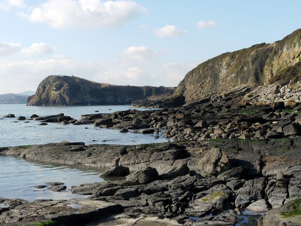 Rocky shore between Glenstocken and Castle Point It was always a childhood challenge to complete the route over the rocks below the cliffs south of Barcloy Hill. The safe route, at high tide, is up and over. The beautiful sandy beach this side of the point can often be yours for the day.