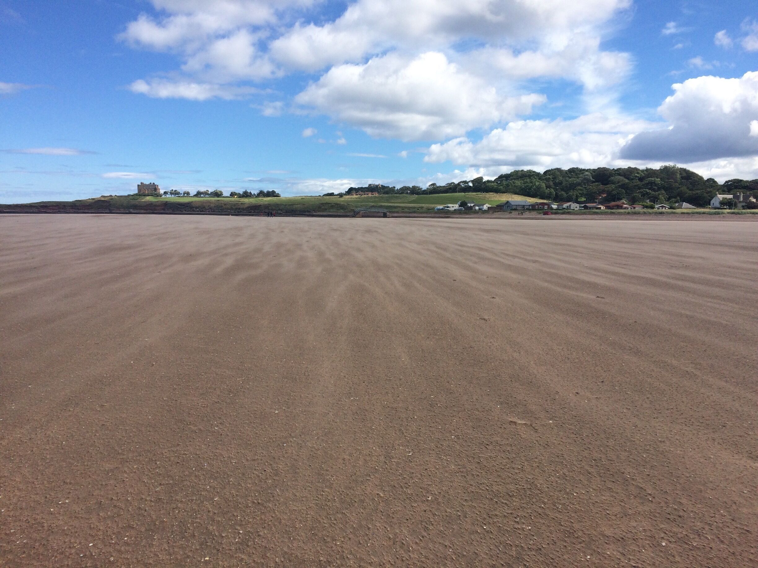 The wind blowing the sand into patterns along the beach
