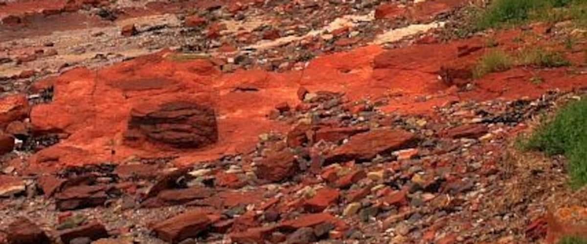 Sedimentary Rocks, Belaven Bay The golf course on the right is on an area of raised beach. During the last ice age it would have been part of the beach, kept there by the weight of the ice.With the melting of the ice the land rose.