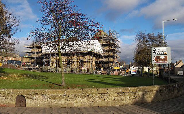 Renovation work at Greenlaw Town Hall. The hall was built between 1829 and 1831 to a Neo-Grecian design by John Cunningham when Greenlaw was the county town for Berwickshire. It was converted into a community centre in 1960 and a swimming pool in 1973 before falling into disuse in the 1990s. The hall featured in the BBC 'Restoration' programme in 2006 and although it was unsuccessful in securing funding from this source, European Redevelopment Fund money has been secured for the restoration of this impressive building. The programme of works is expected to be completed by August 2010. For a view of the hall prior to the erection of scaffolding for the renovation work, see 1041653. An update on the funding campaign for this project:- Historic Scotland made a £500,000 grant towards the overall estimated project cost of £2 million on the condition that the remaining money was raised within a deadline. A local landowner sold off some land for housing and generously donated £255,000 to the fund, and the local community, through fundraising and other successful grant applications, managed to raise the necessary money 2 days before the Historic Scotland grant was due to expire - a fantastic effort by a local community of 600 people. (Source: Scottish Borders Council community newspaper SBconnect).