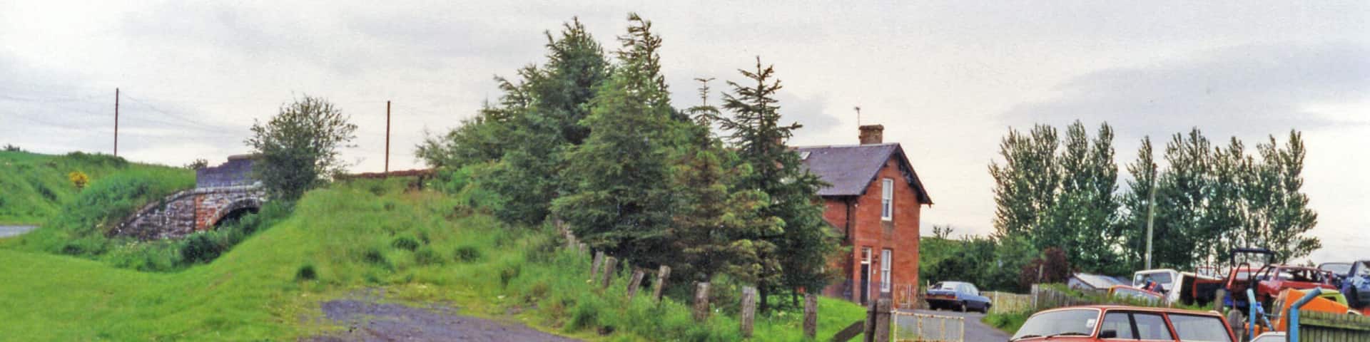 Greenlaw station (site/remains), 1997. View westward, towards Gordon, Earlston and St Boswells: ex-NBR Berwickshire (Reston - Duns - St Boswells) line. The line was severely affected by the great floods of 12/8/48, when 6.28 inches of rain fell in the Borders, turning rivers to raging torrents which destroyed many bridges. With track washed away as well, from 13/8/48 the line was closed Duns - Earlston, but was restored Greenlaw - St Boswells after some months for freight traffic, until complete closure from 19/7/65.