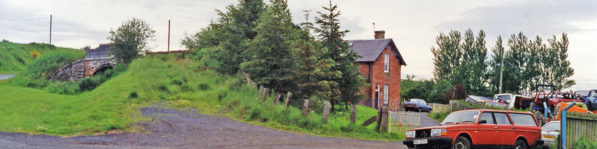 Greenlaw station (site/remains), 1997. View westward, towards Gordon, Earlston and St Boswells: ex-NBR Berwickshire (Reston - Duns - St Boswells) line. The line was severely affected by the great floods of 12/8/48, when 6.28 inches of rain fell in the Borders, turning rivers to raging torrents which destroyed many bridges. With track washed away as well, from 13/8/48 the line was closed Duns - Earlston, but was restored Greenlaw - St Boswells after some months for freight traffic, until complete closure from 19/7/65.