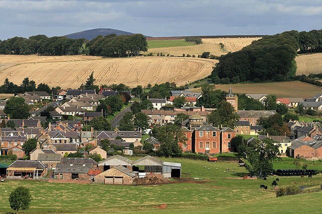 The village of Greenlaw Greenlaw at one time was the county town of Berwickshire but it has never been more than a large village on the south side of the Lammermuir Hills. For more information, see http://www.greenlawtownhall.bordernet.co.uk/greenlaw.html Four squares converge in the village and while the foreground buildings are in the photographers square, the central point is outwith. Viewed from a track to the south near Catmoss.