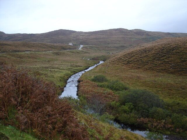 River Sand. Looking Northish along the river, the road to Melvaig can be seen in the background.