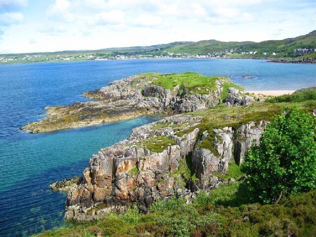 A coastal landscape with rocky cliffs and a body of water.