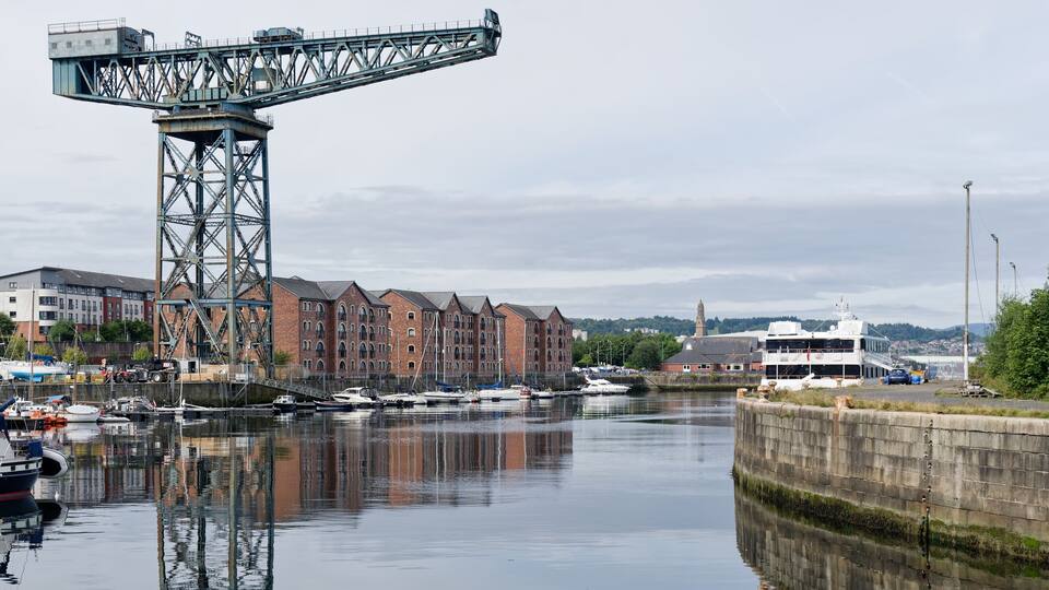 A river with boats, a bridge, and buildings along the banks.
