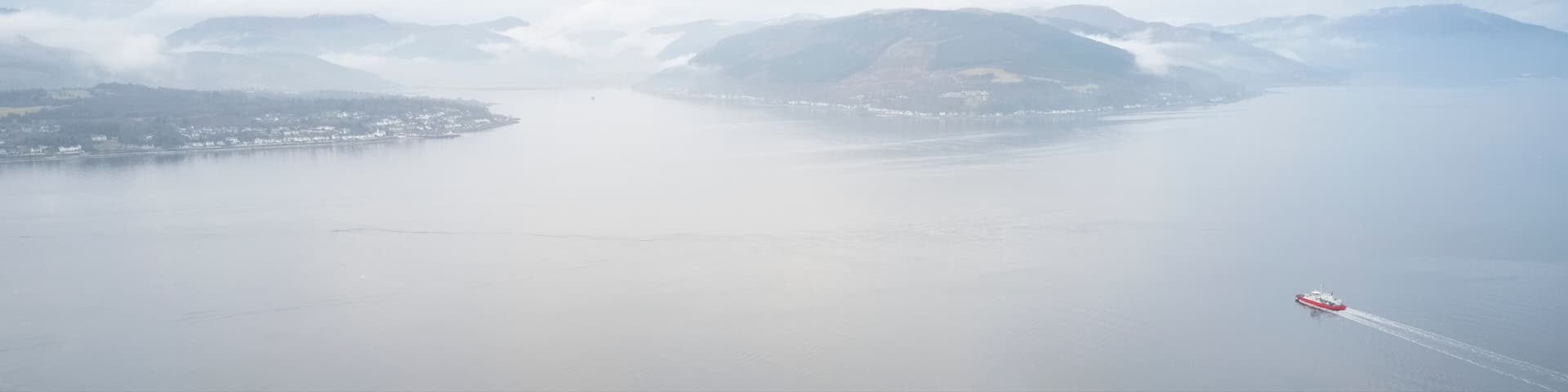Ferry ship crossing on open vast ocean cruise journey aerial view from above during atmospheric weather sea island trip Scotland UK