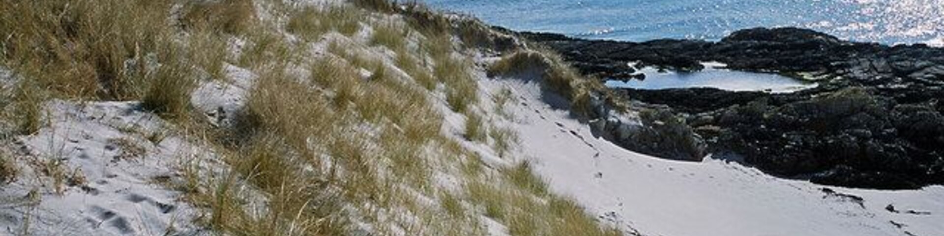 Sand dunes south of Port a Chapuill Perhaps this is the most beautiful corner of Colonsay. It comes into its own in a northerly wind when the dunes can provide effective perfect wind protection. The Paps of Jura dominate the skyline eastwards.