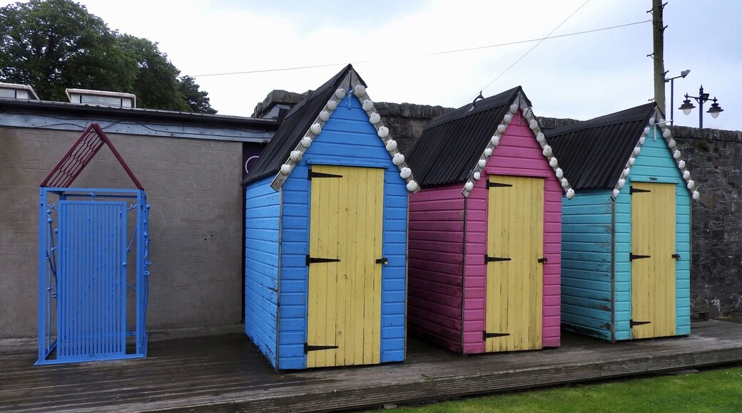 Colourful beach huts in Kirkcudbright (pronounced kirr-koo-bree).