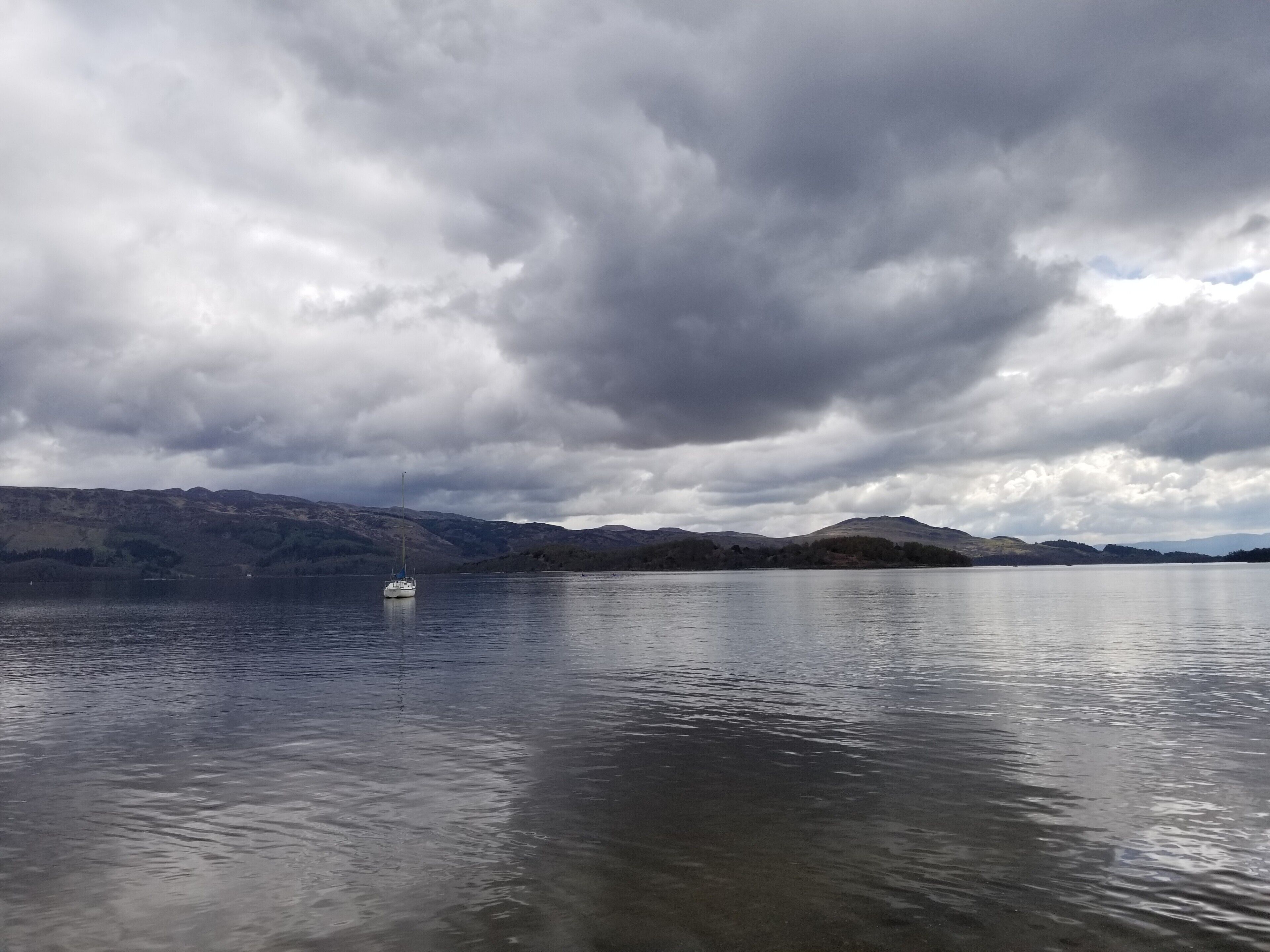 Freshwater Scottish loch on a calm and cloudy day.  
