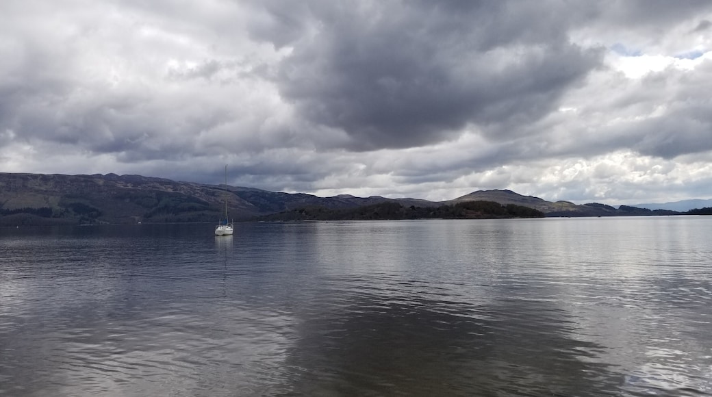 Freshwater Scottish loch on a calm and cloudy day.