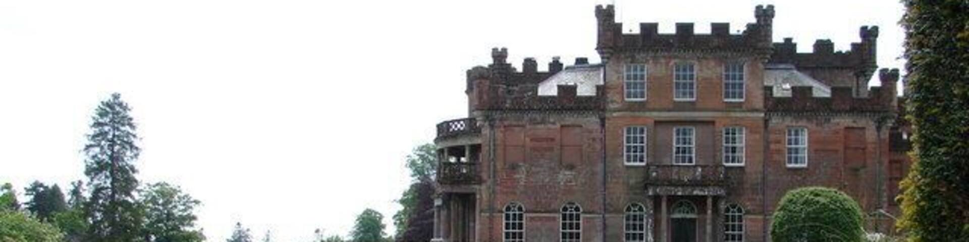 Raehills House North Side Raehills (1782 & 1829-34) is unusual in having Egyptian revival and battlemented details. A colonnade runs above the terrace.