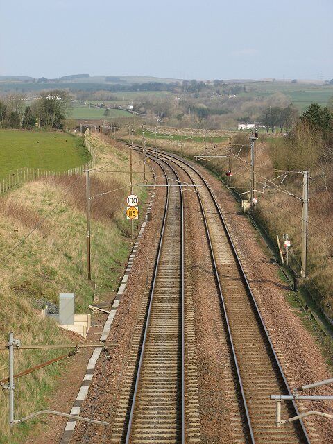 West Coast mainline, Broadlea Looking towards Glasgow. The speed limits are not quite TGV standard and there are two of them. I will stick my neck out and guess that the yellow one is for Pendelino tilting trains, that can take corners faster.