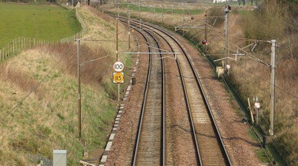West Coast mainline, Broadlea Looking towards Glasgow. The speed limits are not quite TGV standard and there are two of them. I will stick my neck out and guess that the yellow one is for Pendelino tilting trains, that can take corners faster.