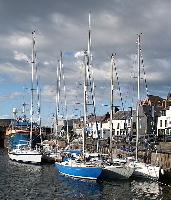 Inner Harbour Usually the quay of the inner harbour is populated with fishing boats, but today they took a back seat - well, most of them; it's a pity the scruffy blue one hadn't been moved to somewhere less conspicuous. The yachts are about to compete in the annual Banff to Stavanger race.