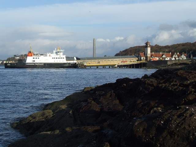 Wemyss Bay station and pier MV Argyle has just arrived from Rothesay. The disused Inverkip Power Station chimney is visible in the distance