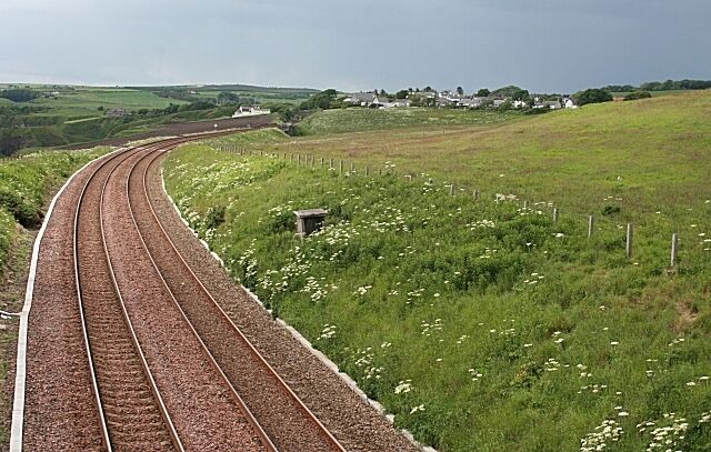 Railway Line at Muchalls Looking south from the overbridge at Mains of Monduff, the main railway to the south from Aberdeen curves round the village of Muchalls. It would have been better with a train in view, but I didn't want to wait any longer as it was about to rain - heavily!