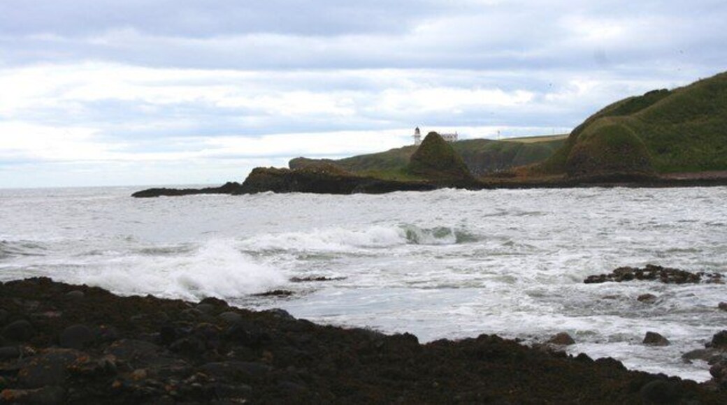 Cattlerline Bay Waves running into Catterline Bay with Forley Craig and Todhead Lighthouse in the distance,