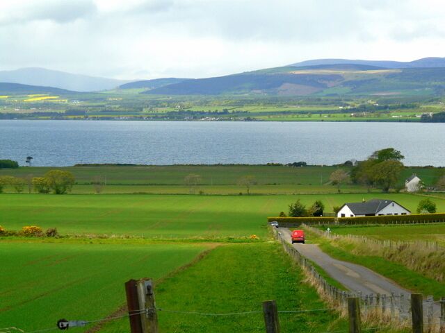 Farmland above Nigg. Nigg Bay in the distance, the "Postie" going down towards Nigg village.