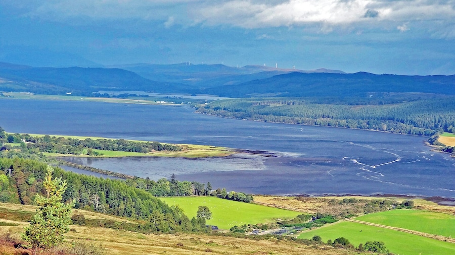 view from the B9176 over Dornoch Firth with Loch Migdale in the far side and a wind farm on the hilltops in the background