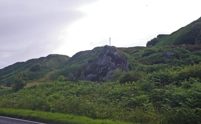 A mountainous landscape with lush greenery and a power line.