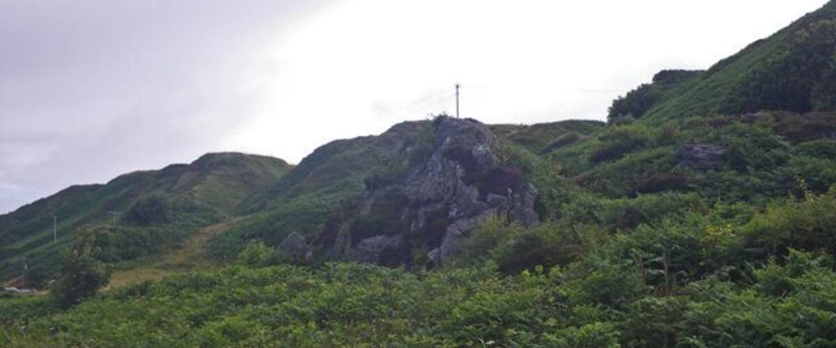 A mountainous landscape with lush greenery and a power line.