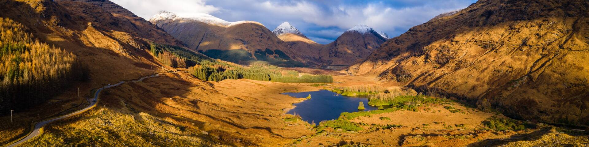 aerial panorama of glen etive and loch etive in the argyll region of the highlands of scotland during autumn and a golden sunset